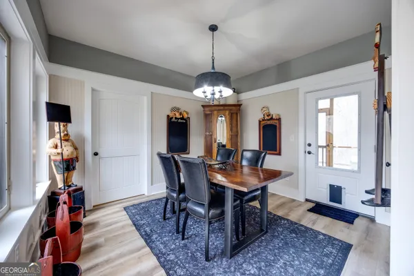 a dining room with furniture window and wooden floor