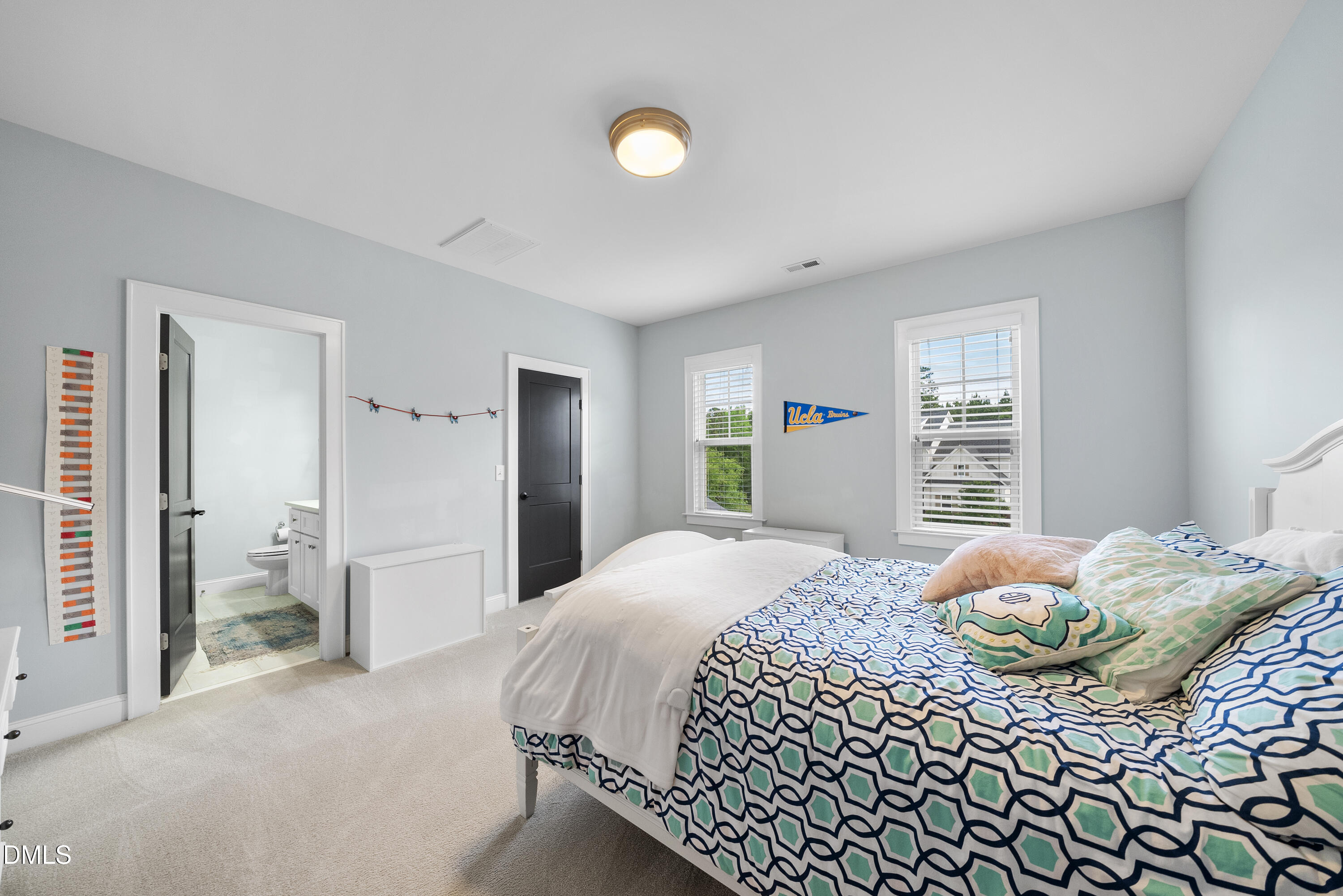 5109 Wainscott Way Raleigh, NC 27612 - Photo 30 of 52 a bedroom with a bed and dresser