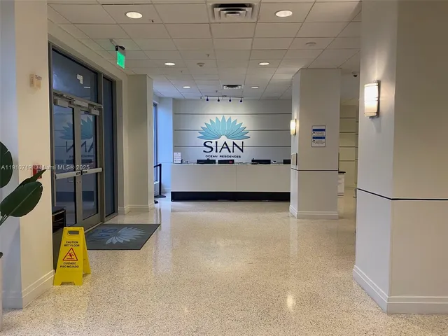 a view of a livingroom with couch and kitchen view