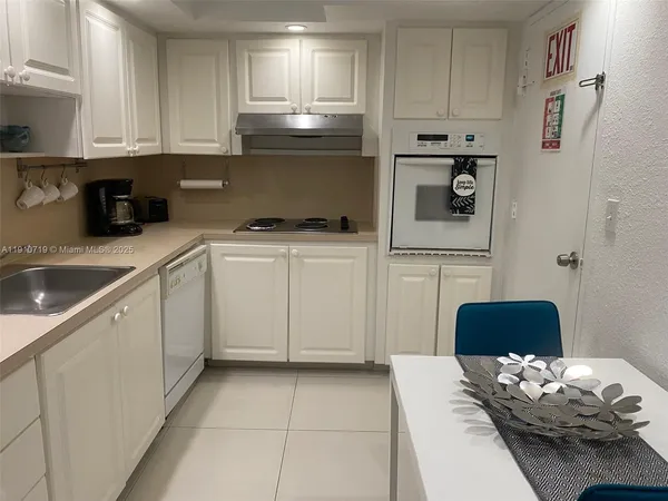 a kitchen with stainless steel appliances a refrigerator and a stove top oven