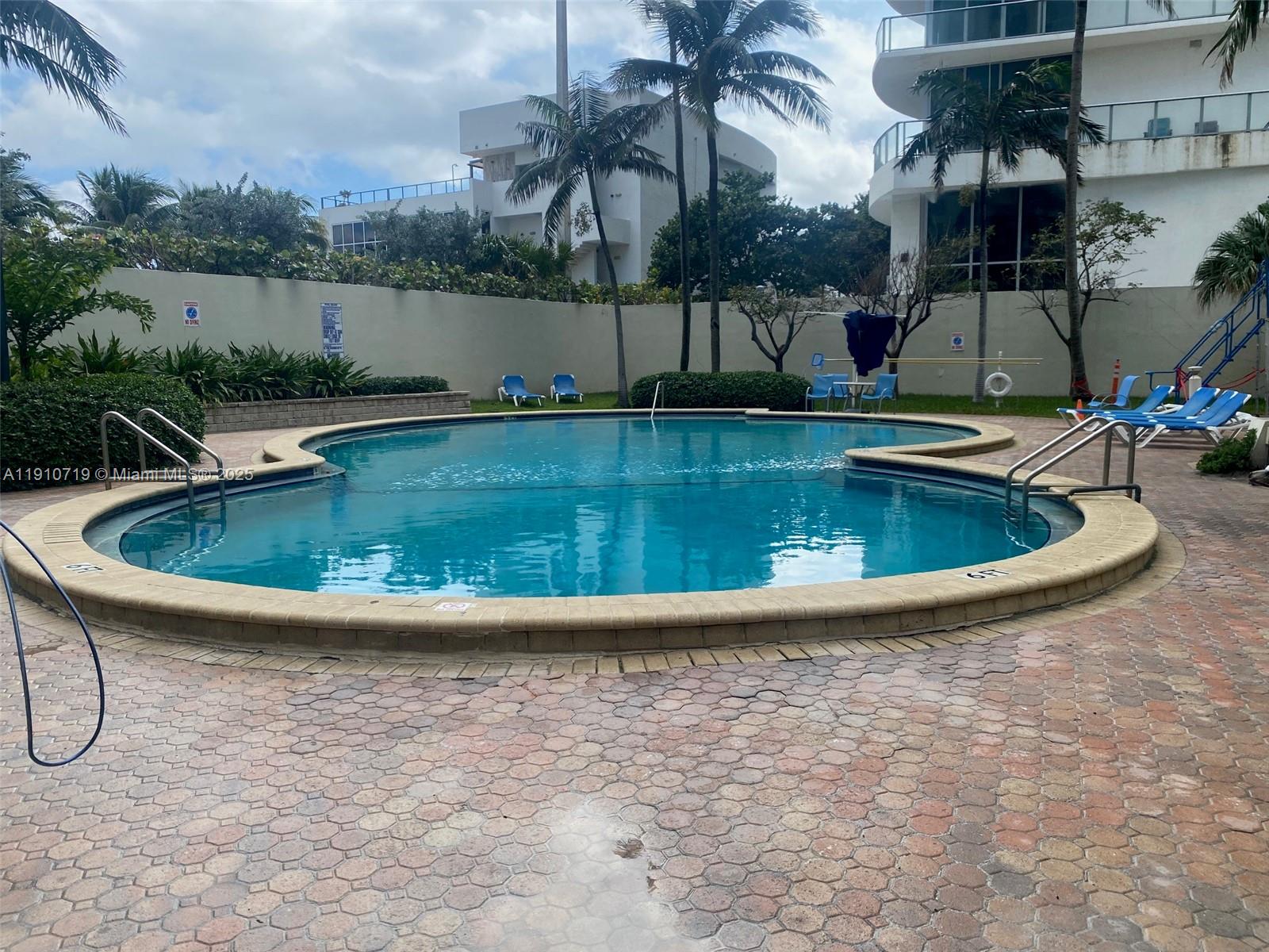 4001 South Ocean Drive, Unit 14F Hollywood, FL 33019 - Photo 3 of 16 a view of a swimming pool with a yard