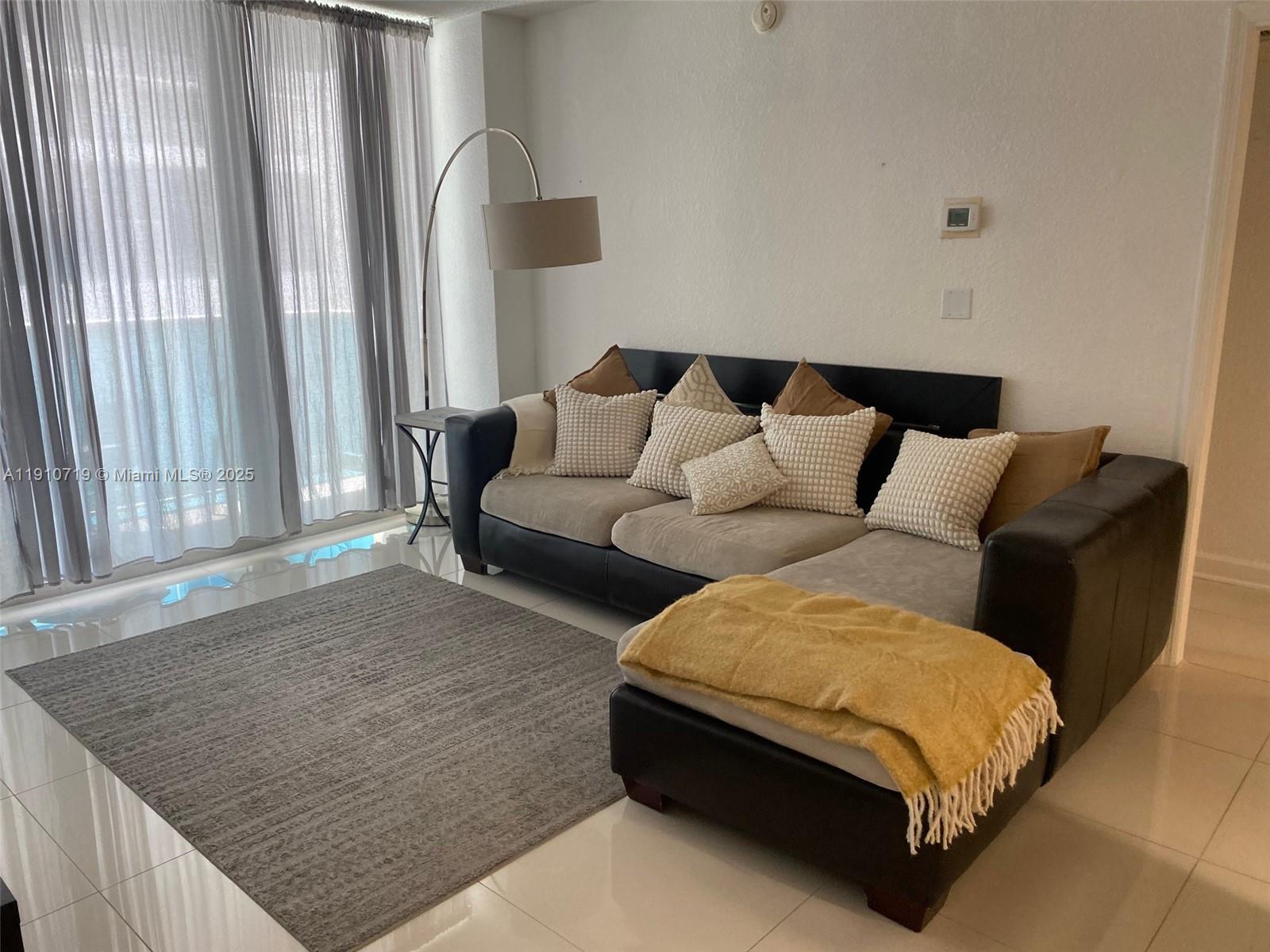 4001 South Ocean Drive, Unit 14F Hollywood, FL 33019 - Photo 6 of 16 a living room with furniture and a window