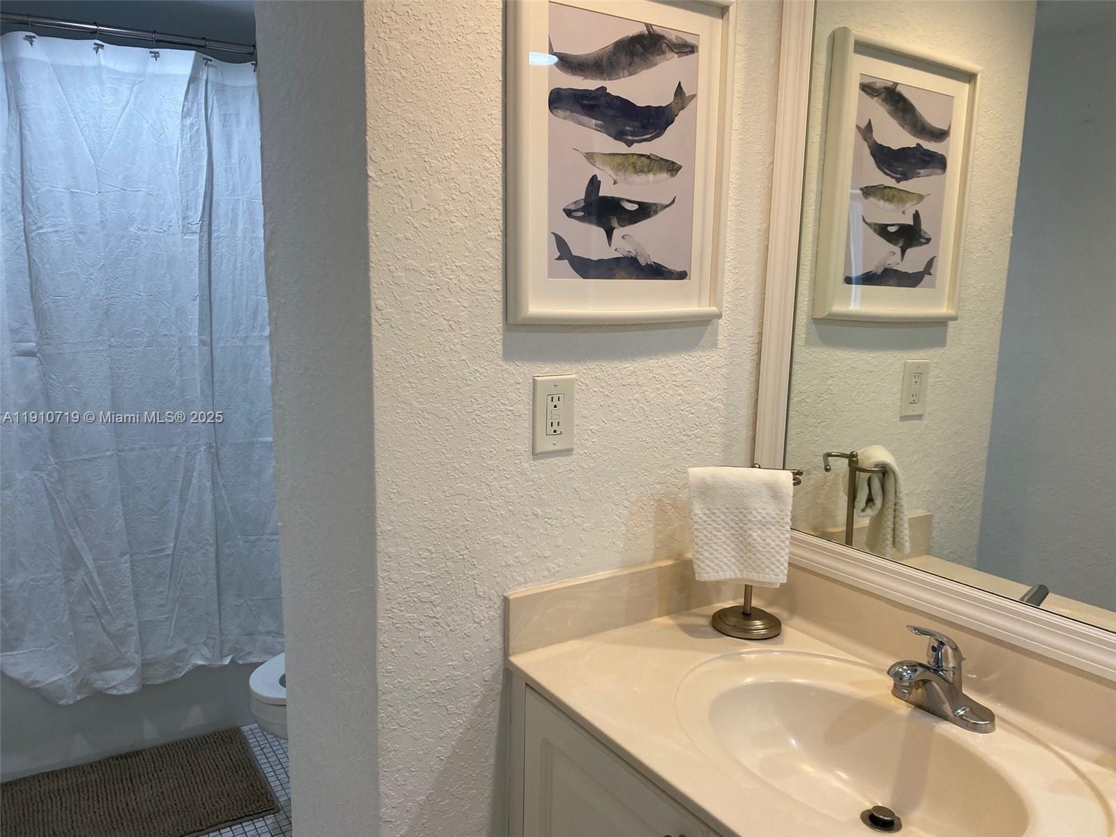 4001 South Ocean Drive, Unit 14F Hollywood, FL 33019 - Photo 9 of 16 a bathroom with a sink and a mirror