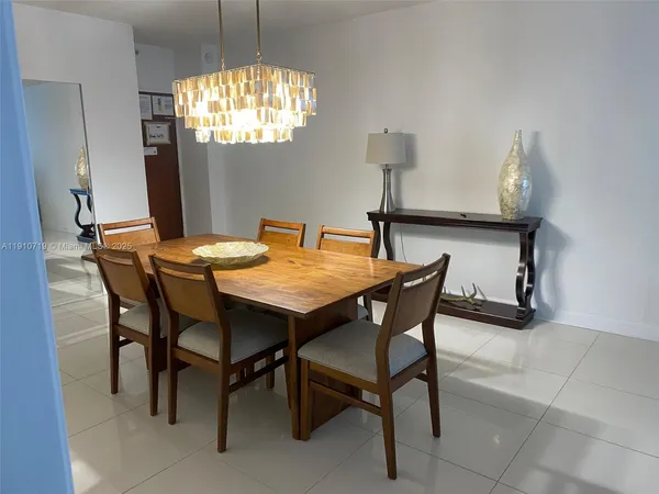 a bedroom with a bed tv and wooden floor