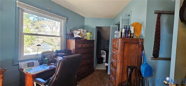 a living room with furniture a window and a flat screen tv