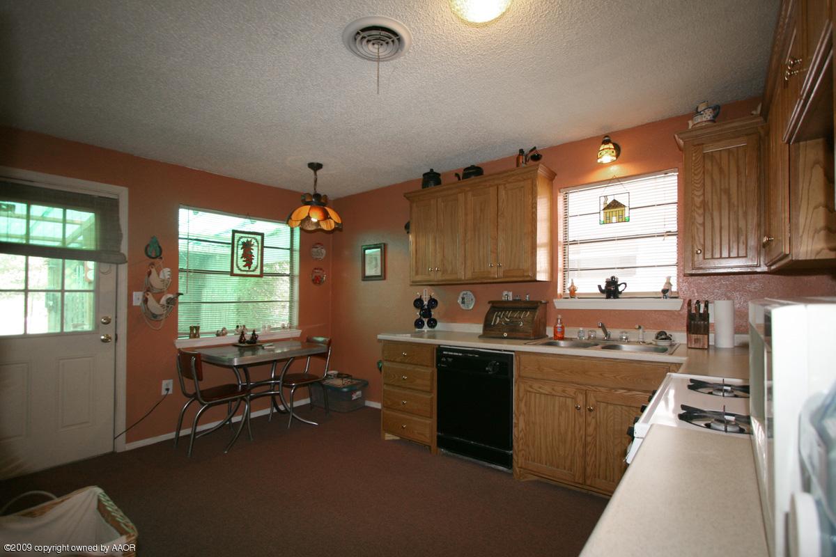 3700 South Harrison Street Amarillo, TX 79110 - Photo 12 of 14 a kitchen with a window a sink and cabinets