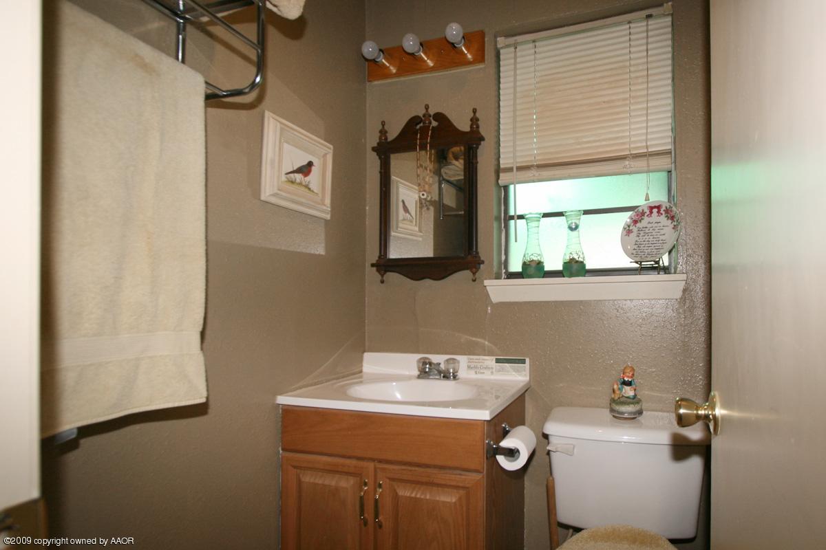3700 South Harrison Street Amarillo, TX 79110 - Photo 4 of 14 a bathroom with a sink toilet and mirror