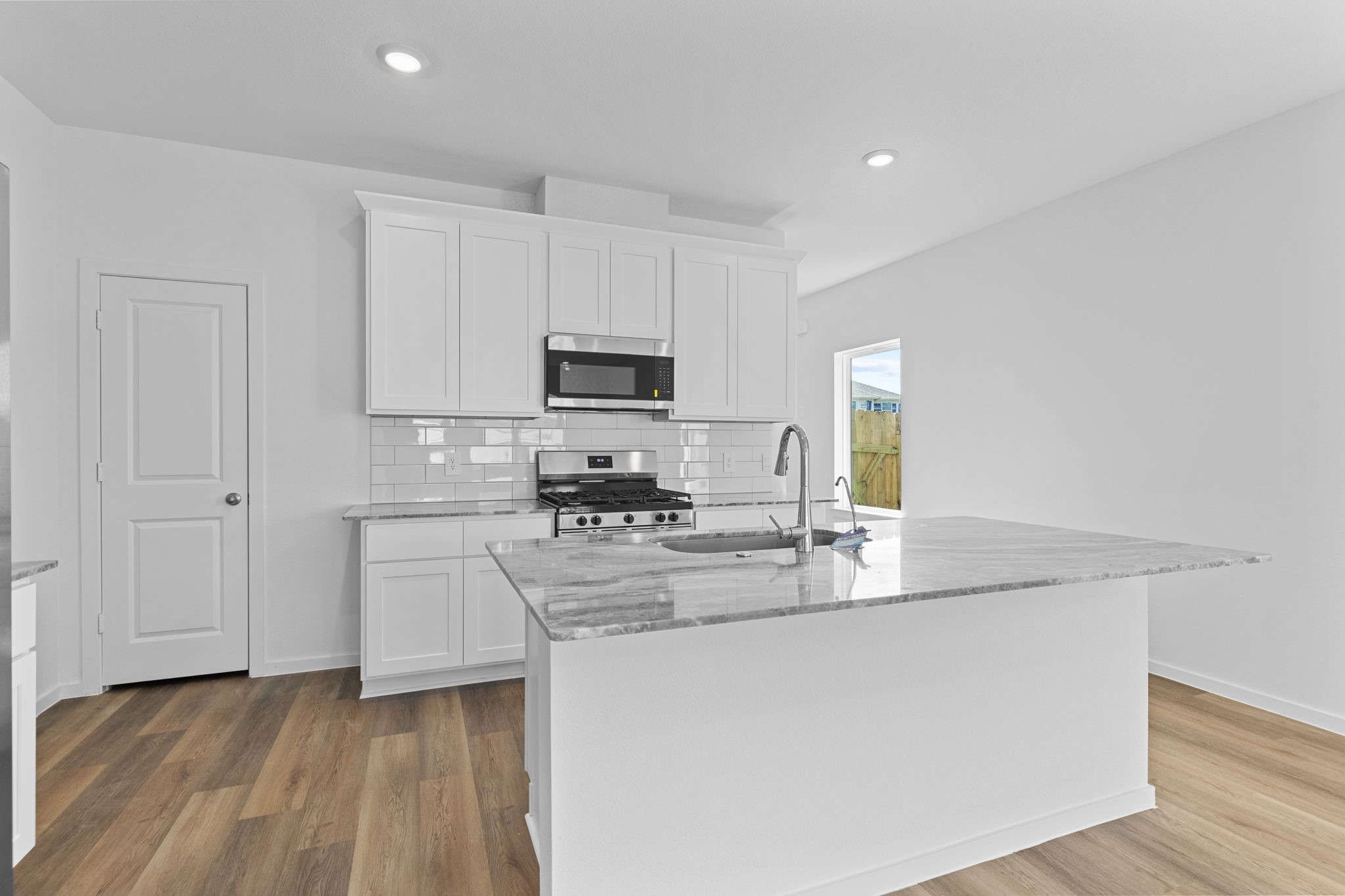 9019 Rose Water Iowa Colony, TX 77583 - Photo 14 of 44 a kitchen with appliances a sink and a counter top space