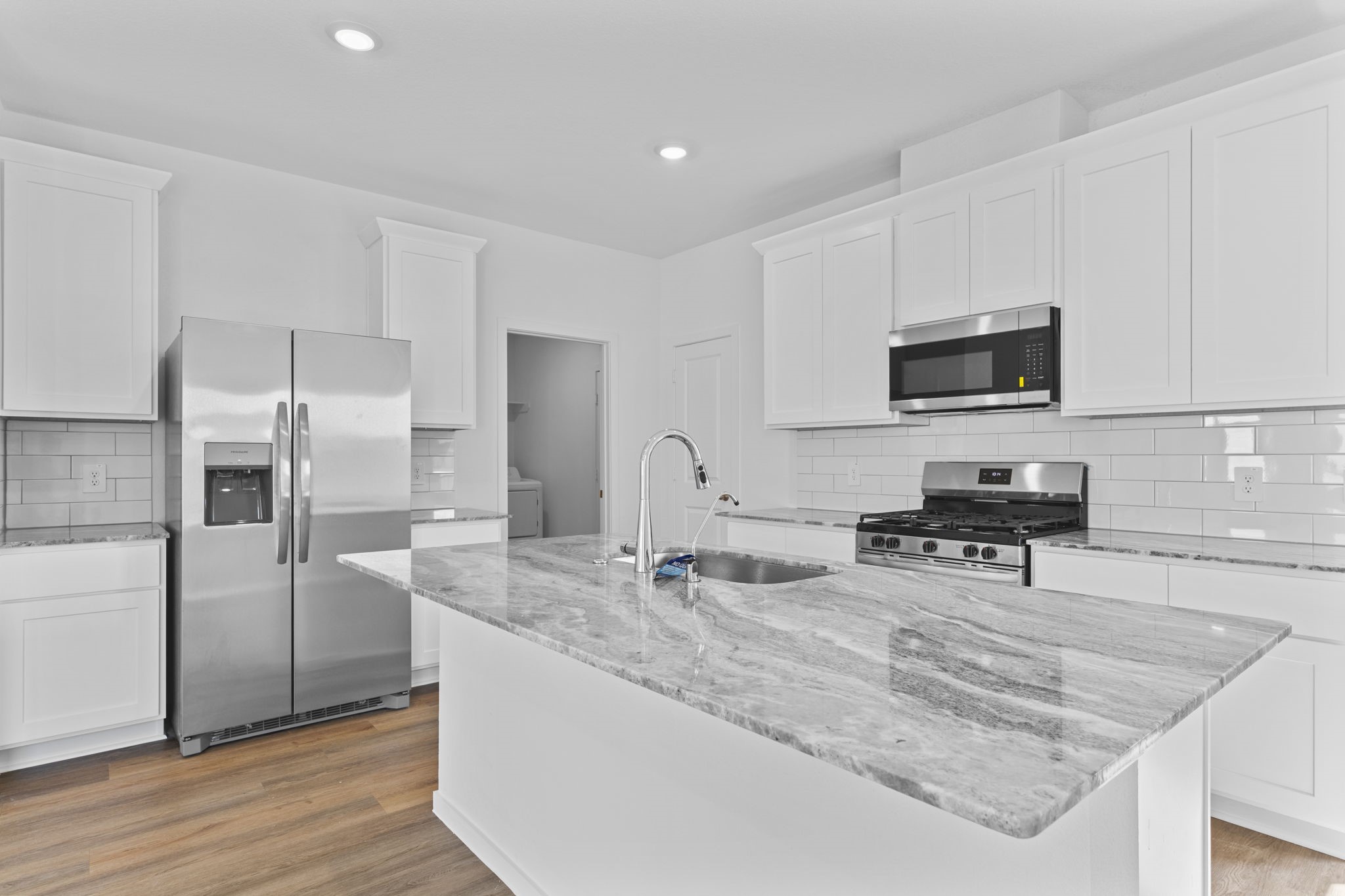 9019 Rose Water Iowa Colony, TX 77583 - Photo 17 of 44 a kitchen with stainless steel appliances granite countertop a sink a stove and a refrigerator