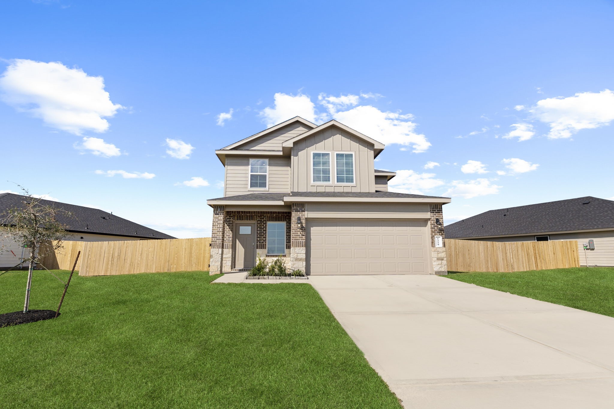 9019 Rose Water Iowa Colony, TX 77583 - Photo 2 of 44 a front view of a house with a yard and garage