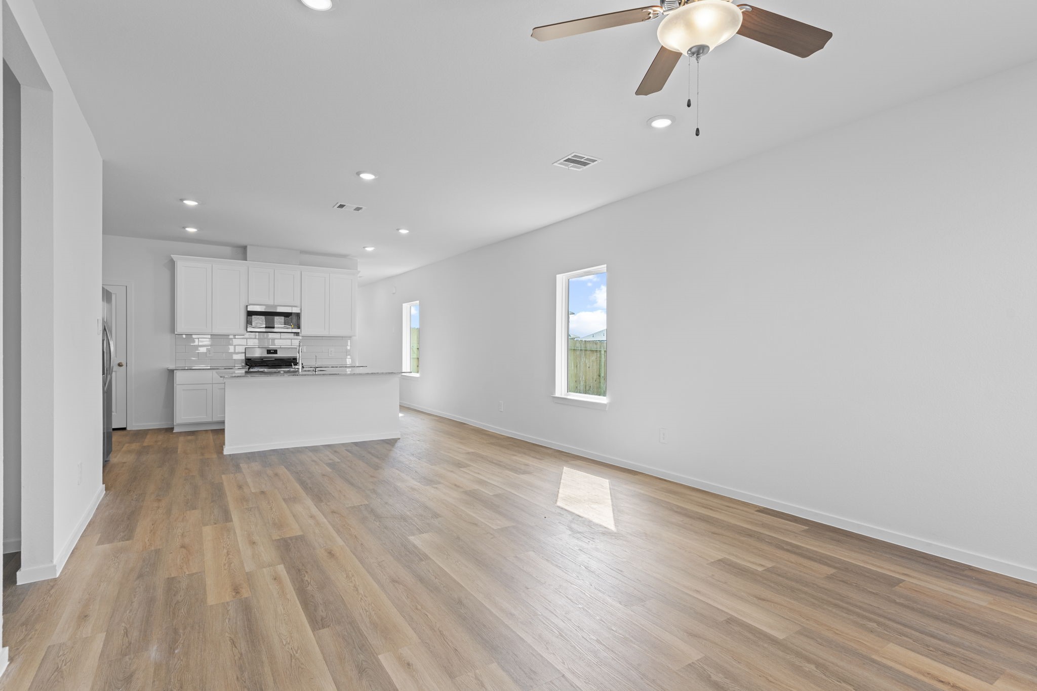 9019 Rose Water Iowa Colony, TX 77583 - Photo 24 of 44 a view of kitchen with wooden floor electronic appliances and window