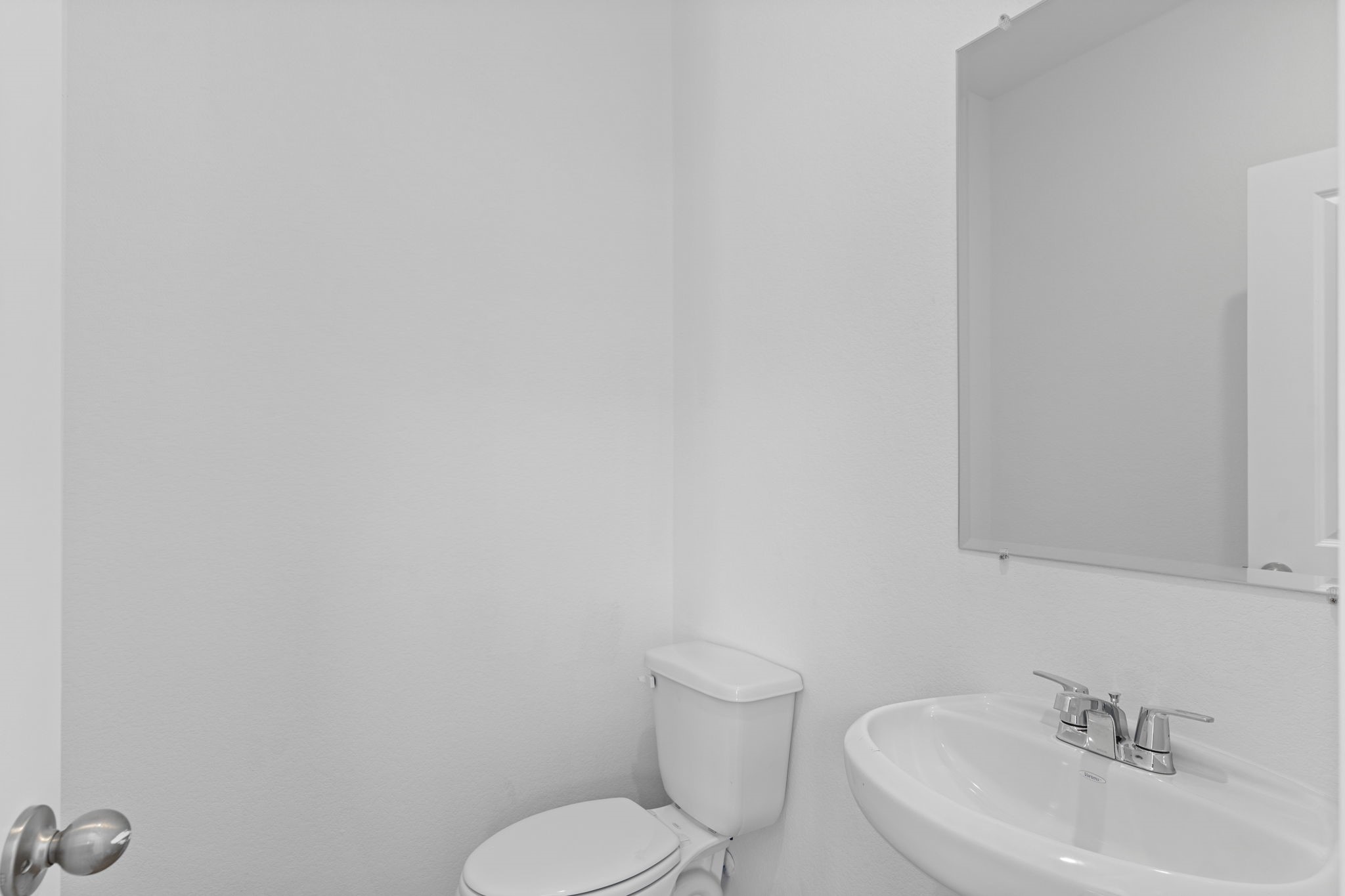 9019 Rose Water Iowa Colony, TX 77583 - Photo 6 of 44 a bathroom with a toilet sink and mirror