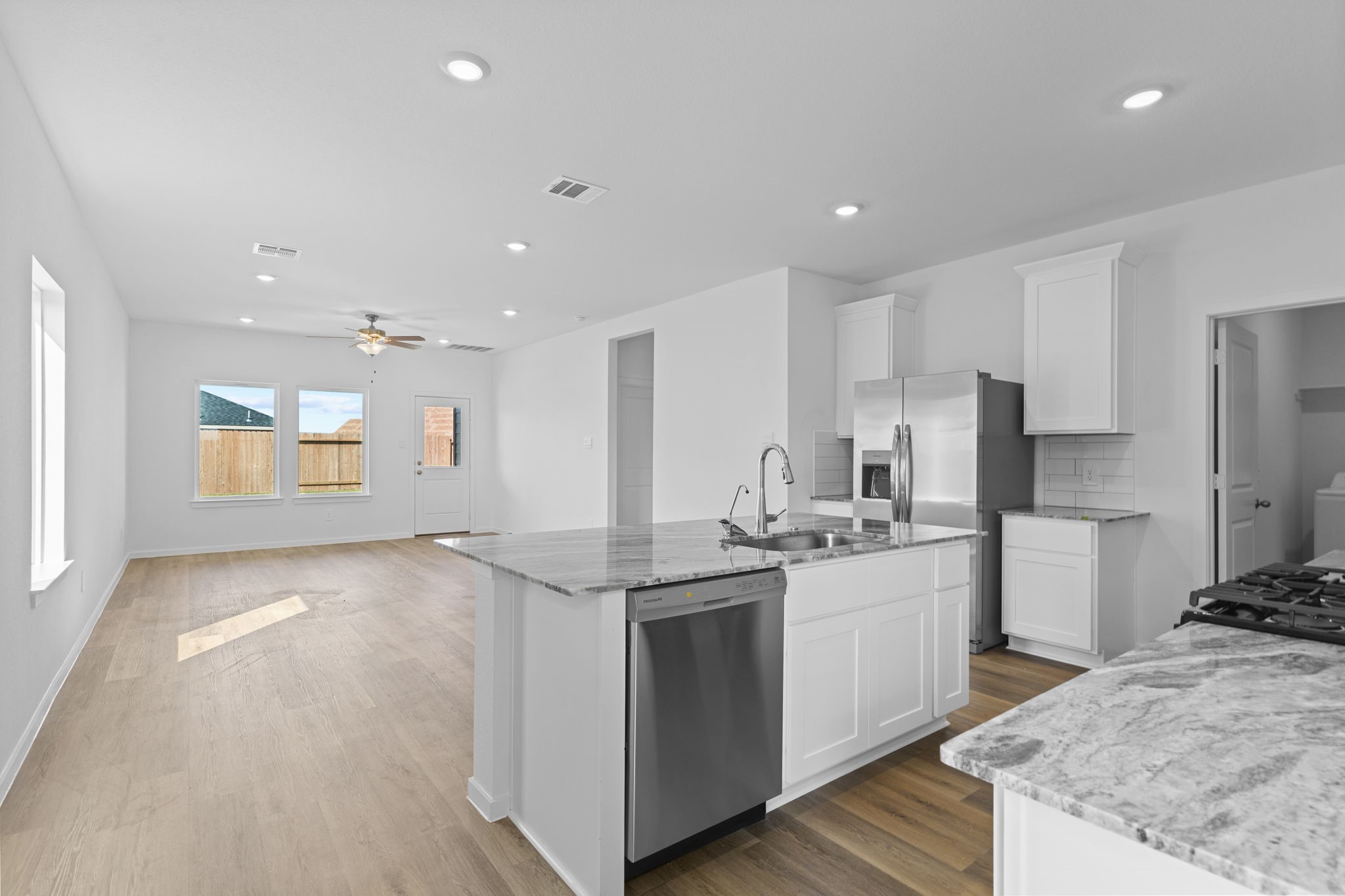 9019 Rose Water Iowa Colony, TX 77583 - Photo 8 of 44 a kitchen with a sink stove and refrigerator