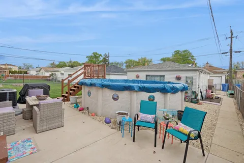 a view of a patio with table and chairs potted plants