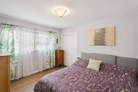 a bedroom with a large bed and a chandelier