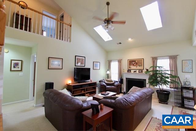 82 Northridge Road Ruckersville, VA 22968 - Photo 4 of 23 a living room with furniture flat screen tv and a fireplace