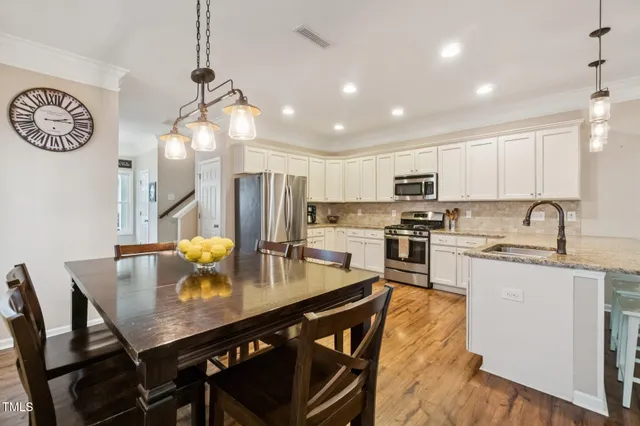 a living room with furniture a flat screen tv and a large window