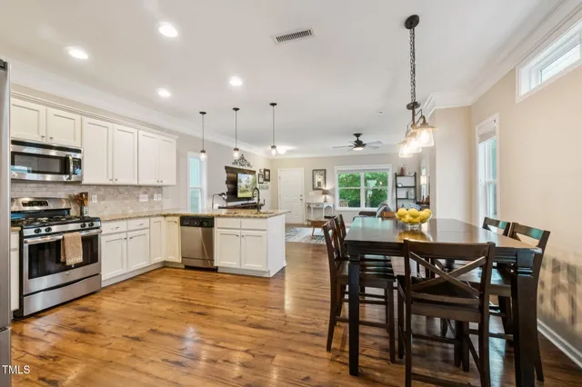 a kitchen with stainless steel appliances granite countertop a sink refrigerator and cabinets