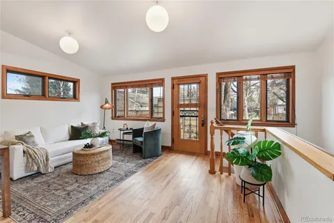 a living room with furniture and a potted plant