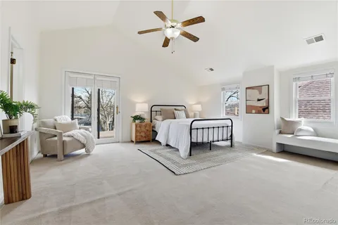 a spacious bedroom with a bed and a couch