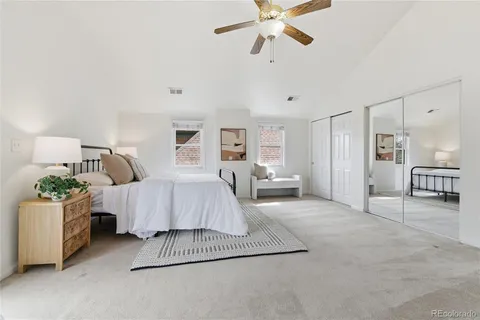 a spacious bedroom with a bed and a chandelier