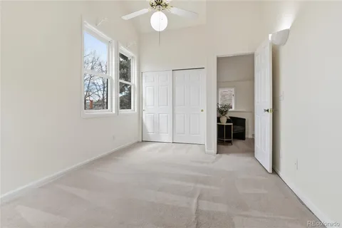 an empty room with windows and closet