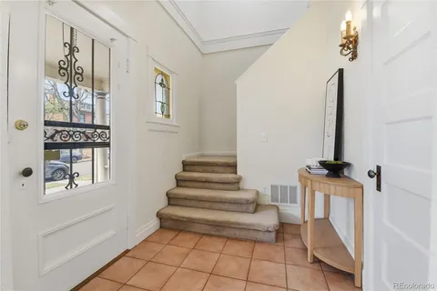 a view of entryway with furniture and wooden floor