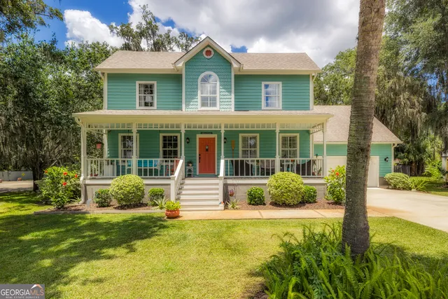 a front view of a house with garden and porch