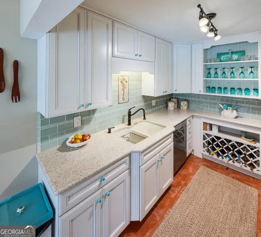 a front view of a house with a yard and potted plants
