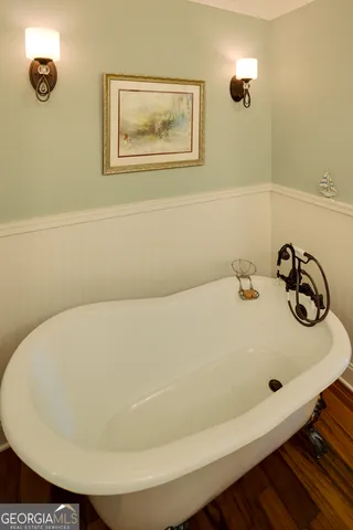 a front view of a house with a yard and potted plants