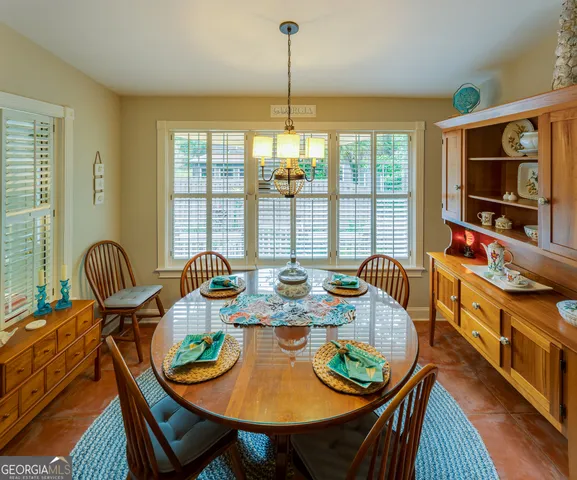 a view of a dining room with furniture window and outside view