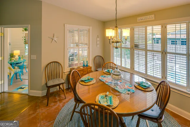 a view of a house with a small yard and wooden fence