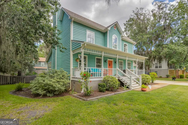 a living room with furniture a rug and a chandelier