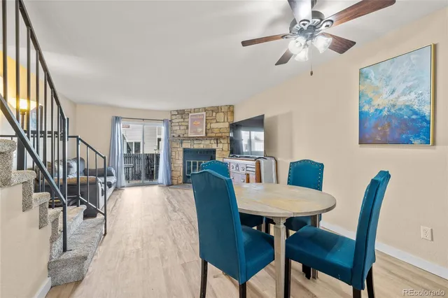 a view of a dining room with furniture a rug and wooden floor