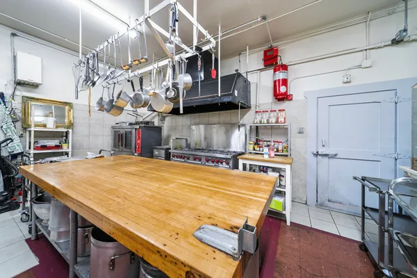 a room with kitchen island a table and chairs in it