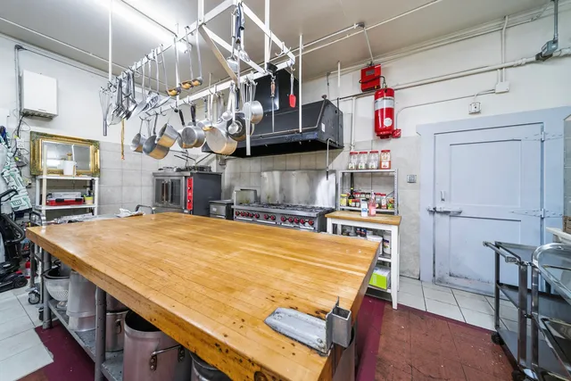 a room with kitchen island a table and chairs in it