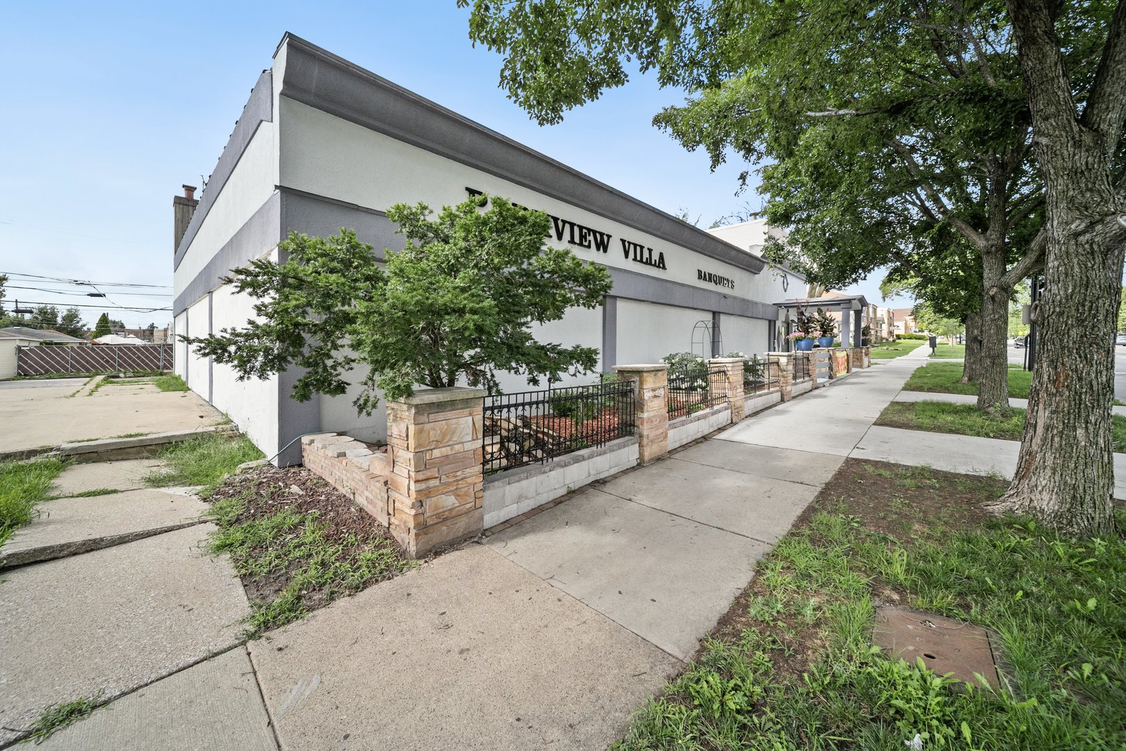 6155 West Fullerton Avenue Chicago, IL 60639 - Photo 2 of 43 a front view of a house with a yard and potted plants