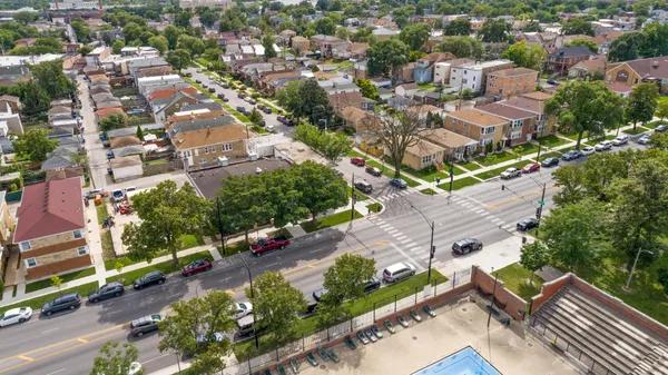 an aerial view of residential houses with outdoor space
