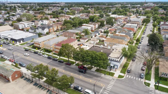 an aerial view of a house with a yard
