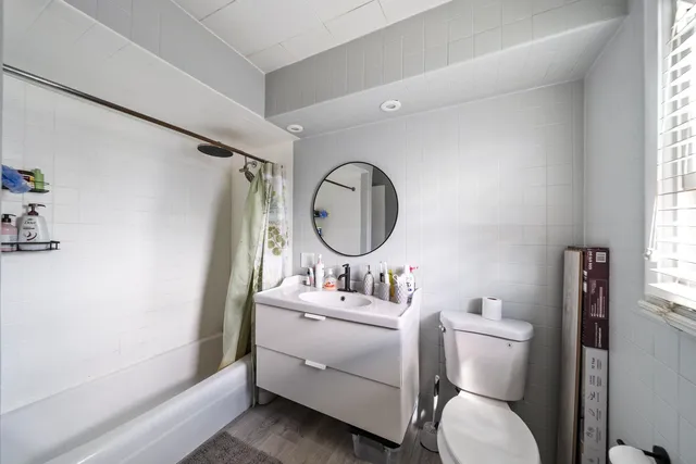 a kitchen with granite countertop a stove a sink and a refrigerator