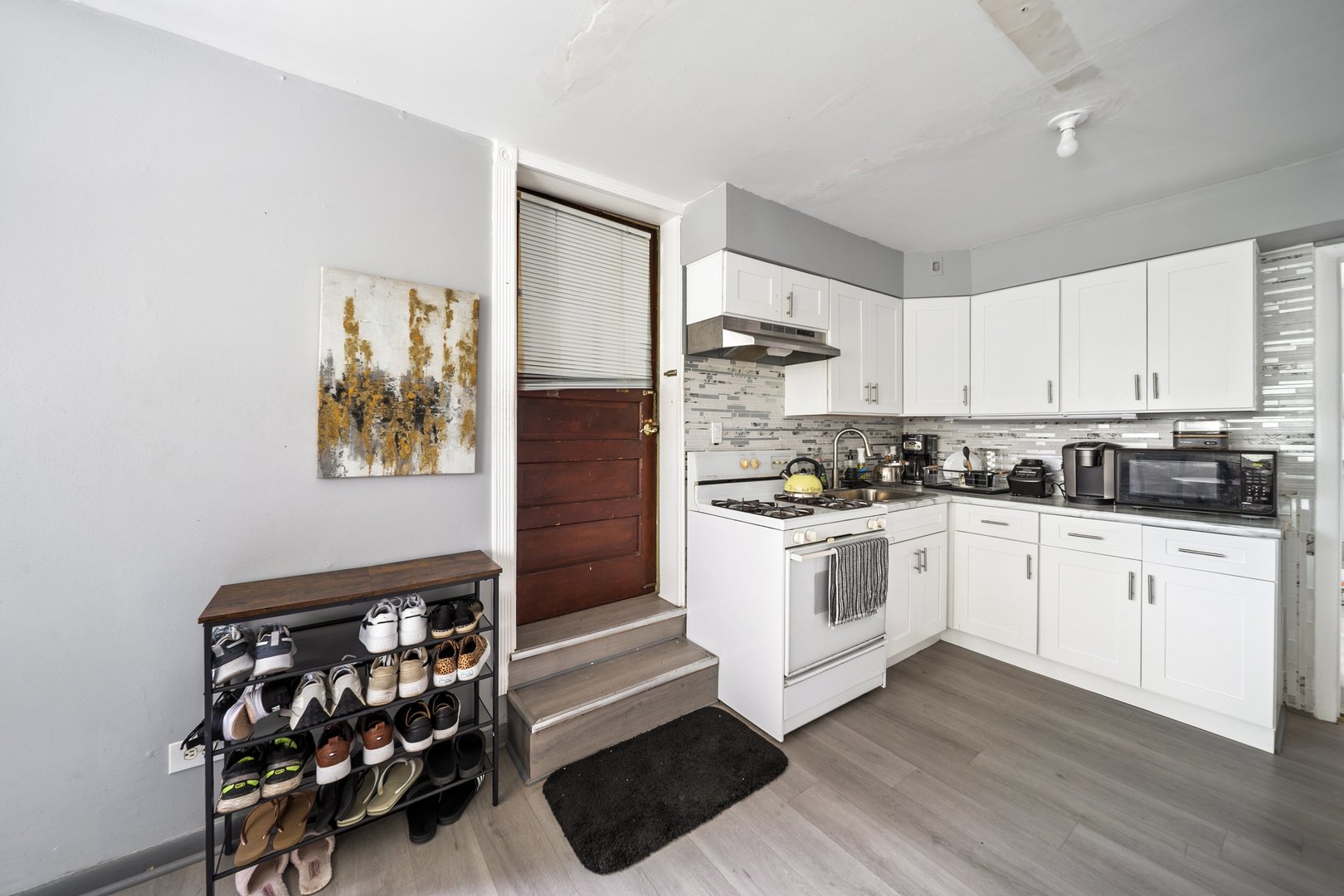 6155 West Fullerton Avenue Chicago, IL 60639 - Photo 29 of 43 a kitchen with granite countertop a stove a sink and a refrigerator