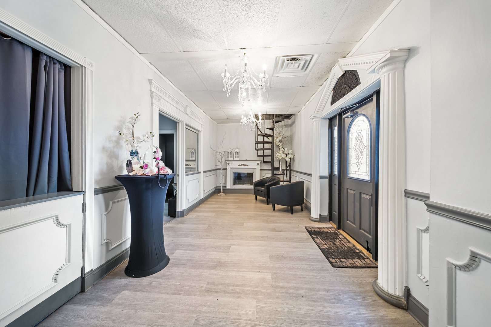 6155 West Fullerton Avenue Chicago, IL 60639 - Photo 6 of 43 a view of a hallway with a dining table a chandelier and a mirror