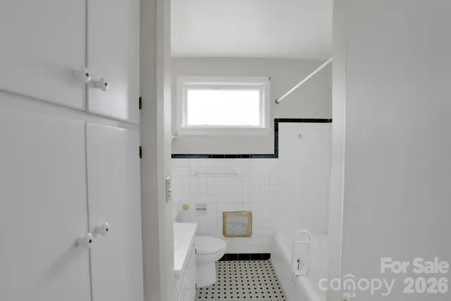 a bathroom with a window a sink and a toilet