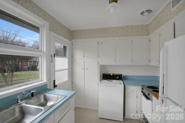 a kitchen with a sink and a refrigerator