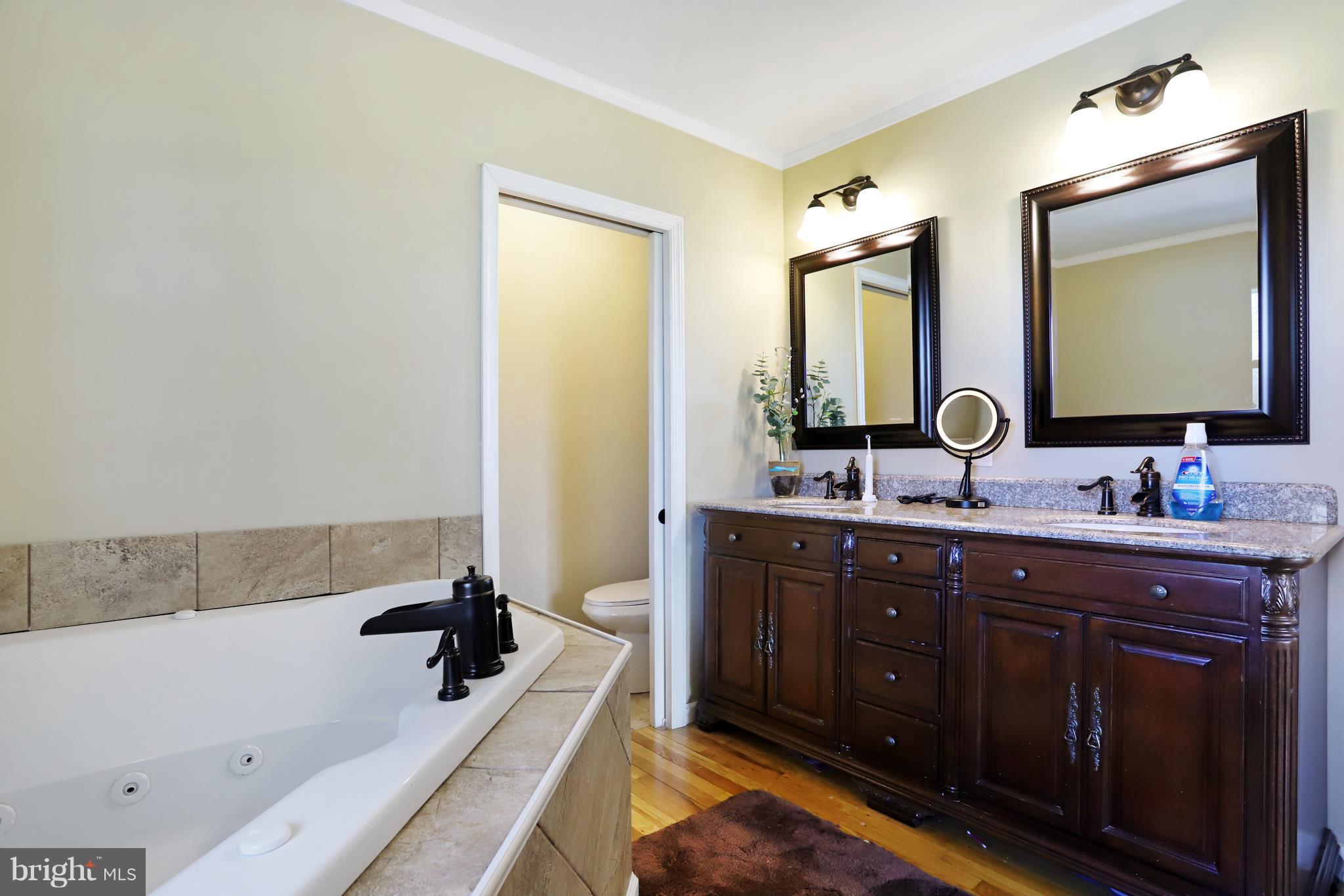 48 Thomas Jefferson Circle Ranson, WV 25438 - Photo 15 of 30 a bathroom with a tub sink and mirror