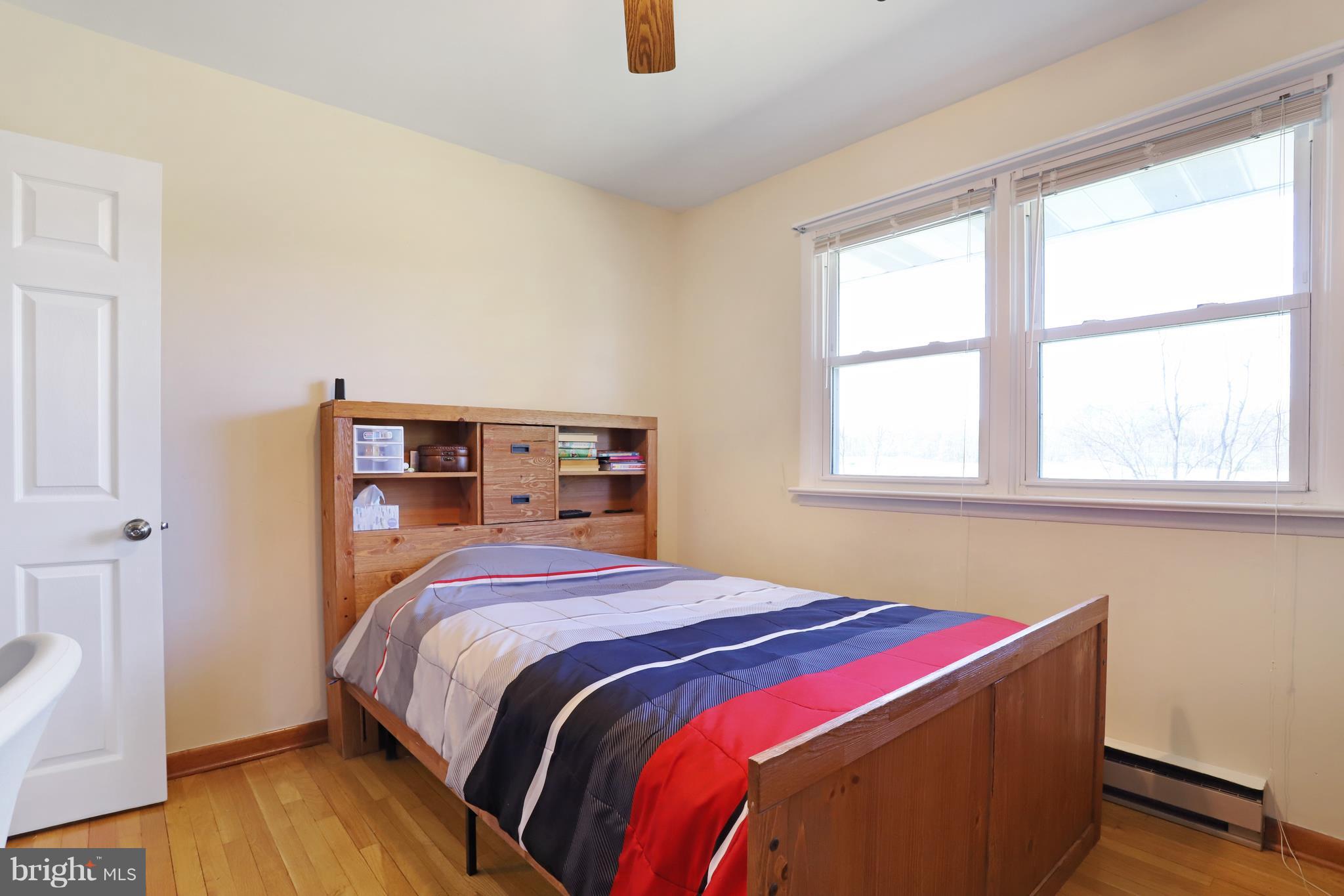 48 Thomas Jefferson Circle Ranson, WV 25438 - Photo 20 of 30 a bedroom with a bed and wooden floor