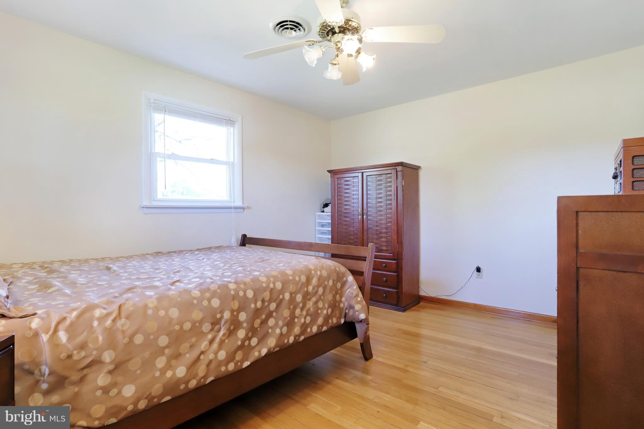 48 Thomas Jefferson Circle Ranson, WV 25438 - Photo 22 of 30 a bedroom with a large bed and chandelier