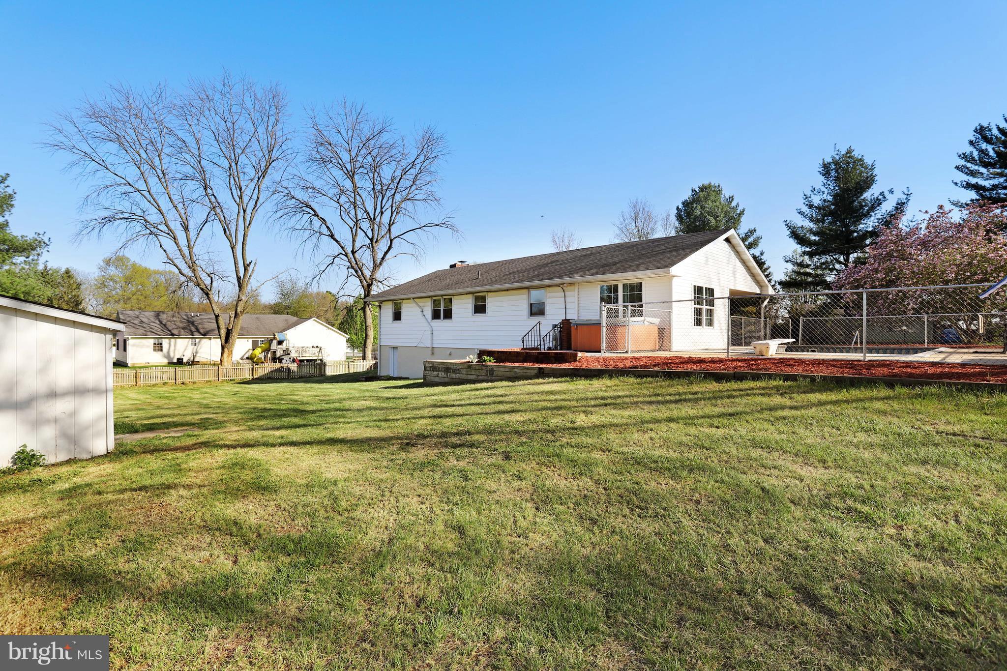 48 Thomas Jefferson Circle Ranson, WV 25438 - Photo 5 of 30 a front view of a house with a garden and trees