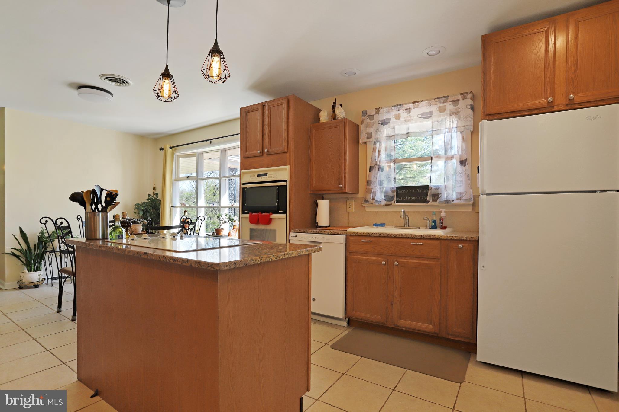 48 Thomas Jefferson Circle Ranson, WV 25438 - Photo 6 of 30 a kitchen with kitchen island a counter top space appliances and cabinets