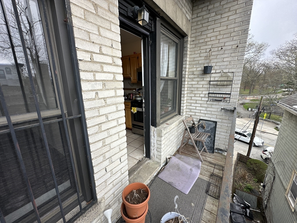 435 Walnut Avenue, Unit 8 Boston, MA 02119 - Photo 11 of 12 a view of a door and chair in the balcony